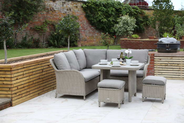 Modular rattan lounge dining set with cushions and stools arranged for outdoor dining