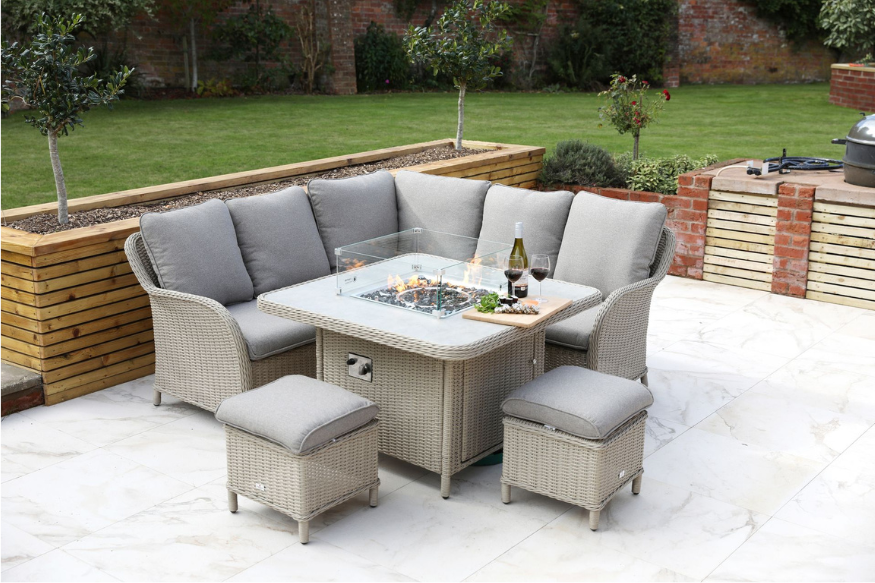 Modular rattan corner seating with square firepit table styled for outdoor dining