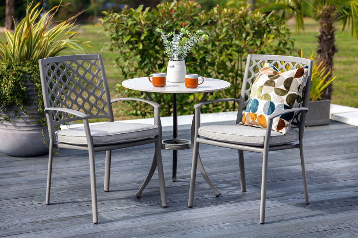 Avebury outdoor patio set with two chairs and a table on a wooden deck.