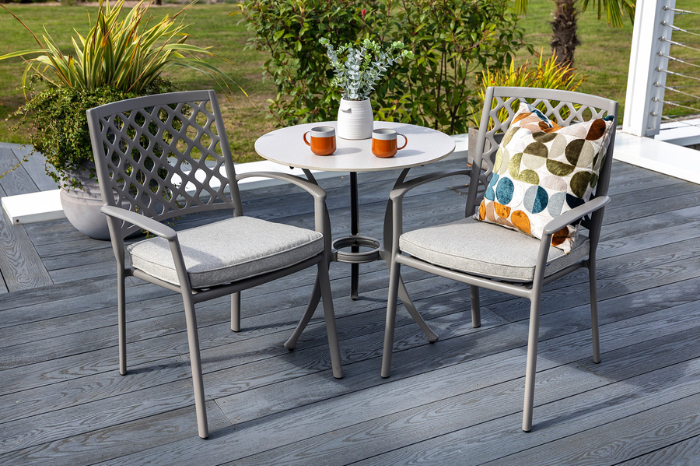 Avebury outdoor patio set with a table and chairs on a wooden deck.