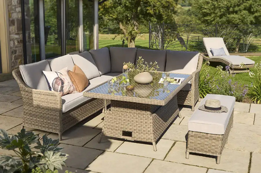Charlbury Signature Corner Set with rattan corner sofa, glass‑top dining table and bench on a garden patio.