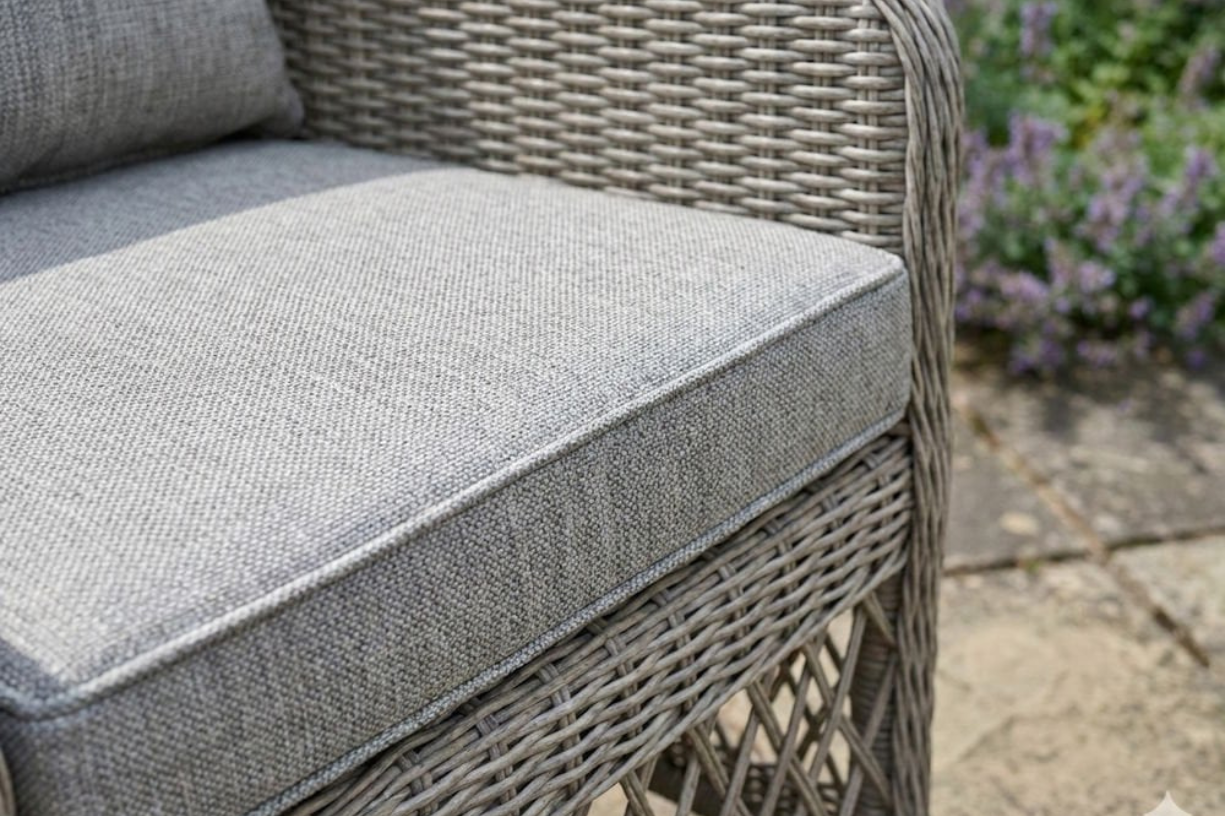 Norfolk Leisure Cotswold wicker bistro set displayed outdoors on a patio for relaxed garden dining.