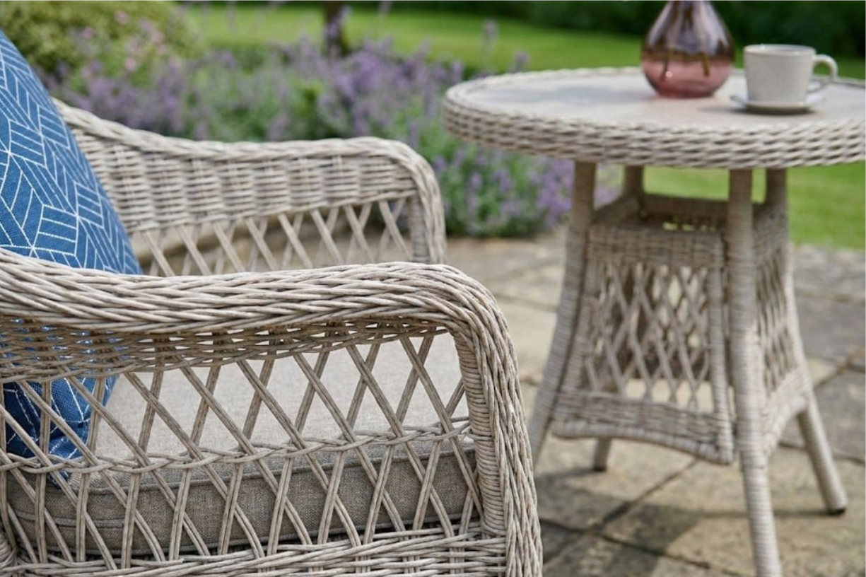 Wicker dining chair with cushion from the Norfolk Leisure Cotswold bistro garden set.