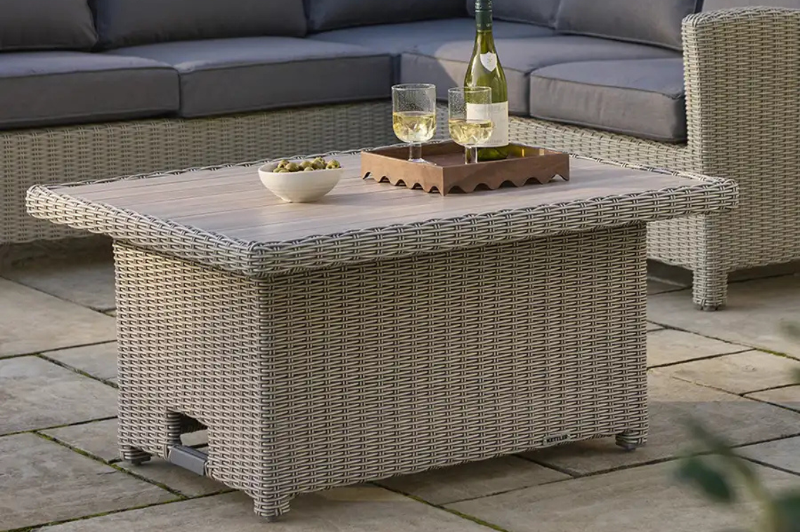 Kettler Palma Slat Top table with wine glasses, and bottle on a stone patio.