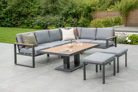 Large corner sofa, matching stools and height-adjustable Polywood table from the Norfolk Leisure Sutton collection displayed outdoors.