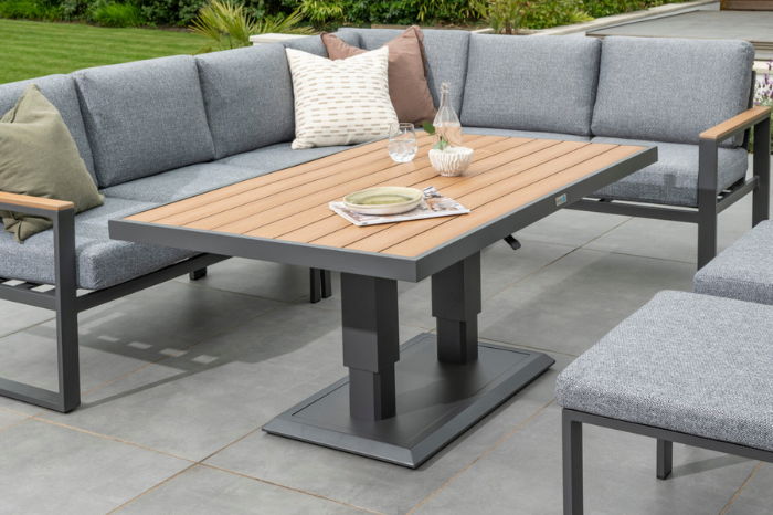 Height-adjustable Polywood garden table paired with the Sutton Large Corner Set, styled with accessories on a patio.