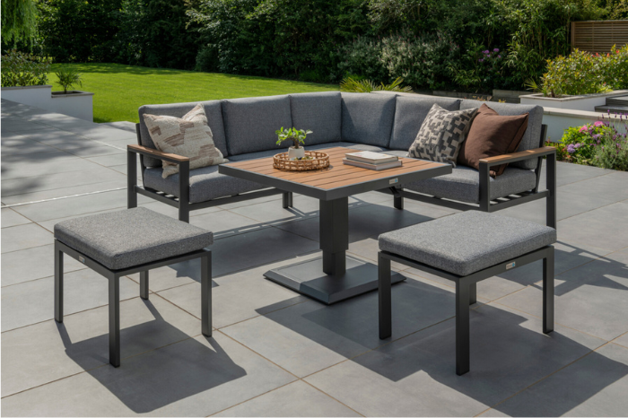 Complete Sutton Mini Corner Set shown in a garden setting with modular corner sofa, stools, and adjustable Polywood table.