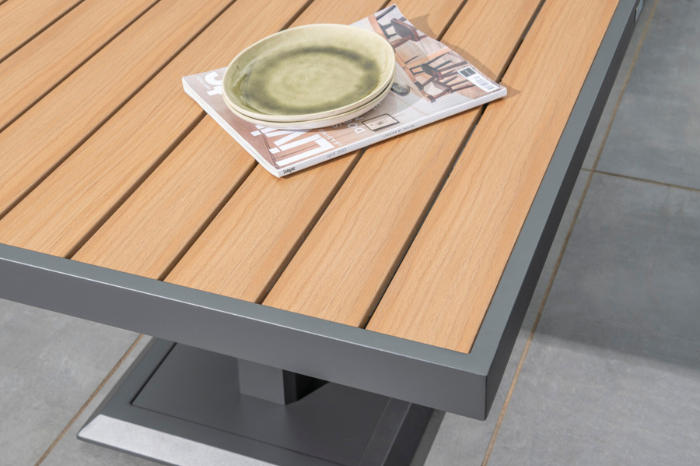 Detail view of the Sutton Mini Corner Set height-adjustable table with durable Polywood slatted top in natural wood-effect finish.