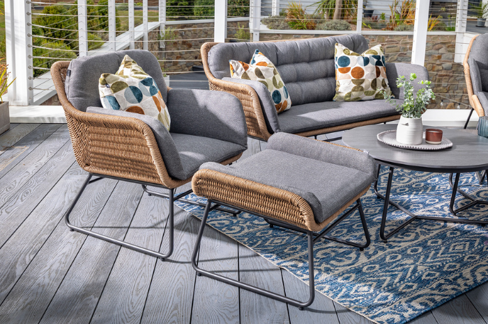 Close-up of woven lounge seating and cushioned stools