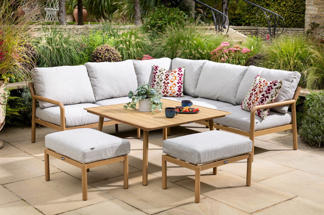 Sahara Square Corner Lounge Set with two matching stools and L-shaped seating, styled outdoors on a stone patio.
