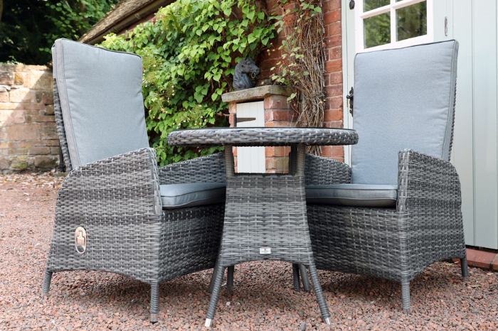 Reclining bistro set with two chairs and round table styled for outdoor dining