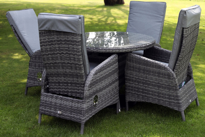 Supremo Tivoli 4 seat round reclining dining set arranged on a lawn